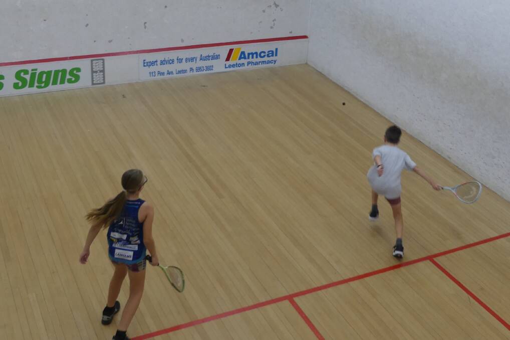 In a match between two of the squash club's juniors, Bear Wynn stretches out to reach a forehand shot against Rose Looby. Picture supplied 