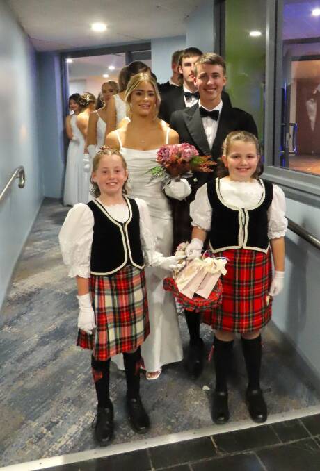 Debutantes and their partners prepare to be presented, with the young flower girls leading the way. Picture supplied 
