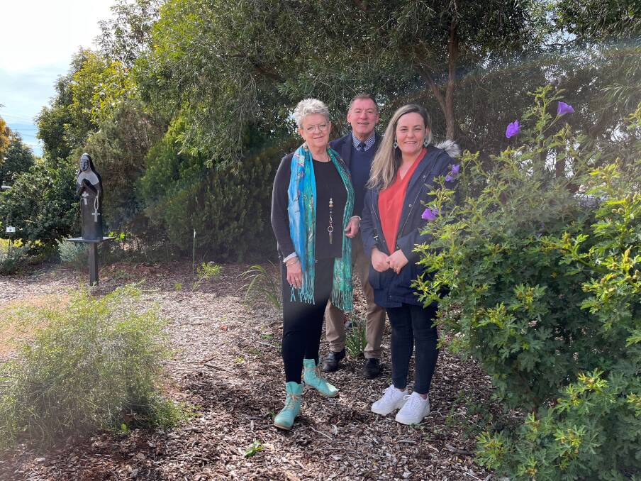 WELCOMING: College staff Janice Drew, Seb Spina and Tinyka Tabain in the garden, which includes a statue of Mary MacKillop. Photo: Talia Pattison