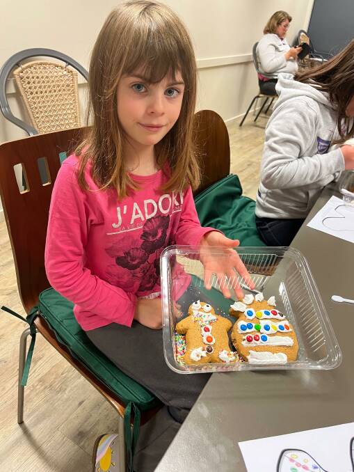 Charlotte Preston, 8, shows off her biscuit decorating skills during the activity at the library. Picture by Talia Pattison
