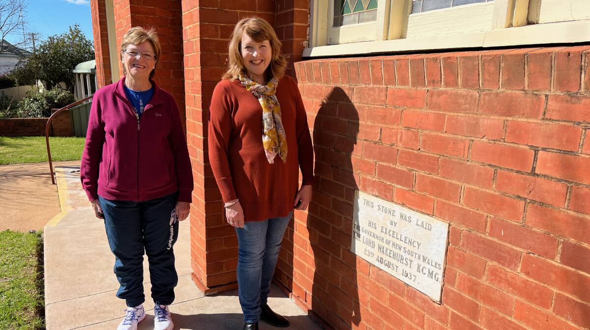 Alanna Rolfe (left) and Megan Martin with the stone commemorating the opening of the "new" church in 1937. Picture Talia Pattison