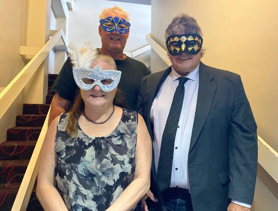 MYSTERY: Wendy and Rod Heffer (front) with Nick Di Pompo (back) wearing their masks ahead of the Rotary Club of Leeton Central's masquerade ball. Photo: Talia Pattison