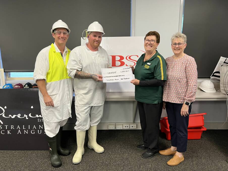 JBS plant manager Brett Meads and staff member Michael Basham present the funds to Mary and Maude from Leeton Can Assist. Picture supplied 