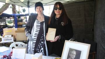 Leeton writer and published author Mel Ifield (left) and Jim Grahame's great grand daughter Phillipa Hollenkamp with a copy of his original poetry book. Picture by Talia Pattison