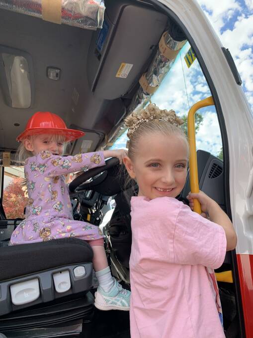 The Walker sisters have a great time exploring one of the fire trucks during the recent open day. Picture supplied 